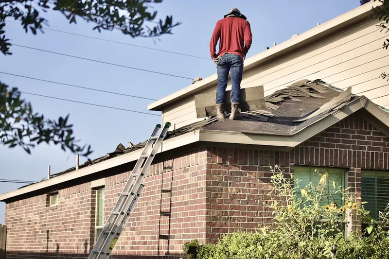Professional roofer working on a residential roof in Womelsdorf